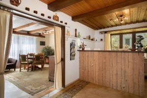 a kitchen and dining room with a sliding barn door at Hotel Garni Vitamari in Wasserburg