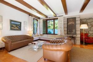 a living room with a leather couch and a table at Casa de Santo António Moledo in Moledo