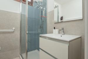 a bathroom with a shower and a sink at Villa Poldina in Budoni +35 photos