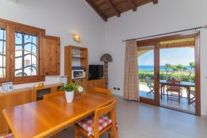 a dining room with a table and a view of the ocean at San Teodoro Villa Nina Costa Caddu in San Teodoro