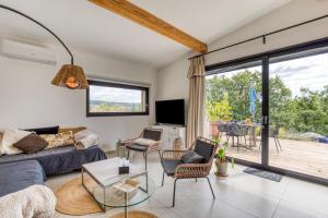a living room with a couch and a table at Le Mas de Coeur in Bédarieux