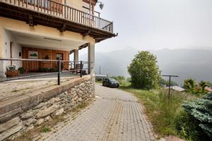 a car parked next to a building on a road at Agriturismo Soleil Levant Torgnon in Torgnon