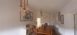 a dining room with a table and a bike on the wall at Casa de Canelas - Refugio Terroir in Açoreira
