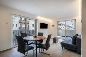 a living room with a table and chairs and a couch at Ferienwohnung Lamm 4 in San Valentino alla Muta