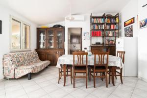 a living room with a table and chairs and a couch at Casa nel centro di Budoni in Budoni