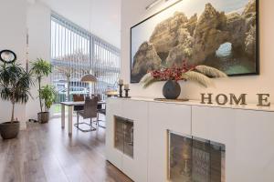 a living room with a fireplace and a painting on the wall at Idylisches Ferienhaus in Edewecht