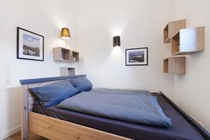 a bedroom with a bed with blue sheets on it at Idylisches Ferienhaus in Edewecht