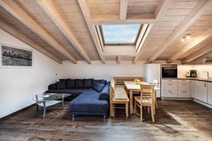 a living room with a blue couch and a table at Panoramawohnung Annaheim in Rifiano