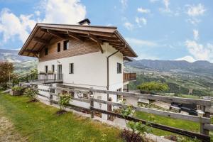 a small house on a hill with a fence at Panoramawohnung Annaheim in Rifiano