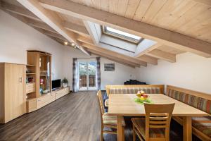 a kitchen and dining room with a table and chairs at Panoramawohnung Annaheim in Rifiano +21 photos