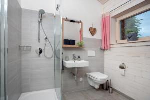 a bathroom with a shower and a toilet and a sink at Ferienwohnung Junge in Halblech +19 photos