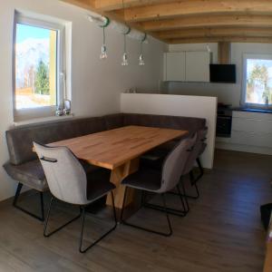 a kitchen and dining room with a wooden table and chairs at Ferienhaus Seltschach 193 in Arnoldstein