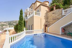 a villa with a swimming pool and a house at Villa Estrella de Cotobro in Almuñécar