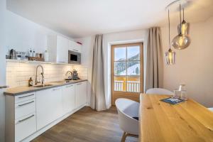 a kitchen with a table and a dining room at Mountain Residence Kasern Nr 2 in Predoi +14 photos