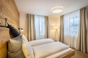 a hotel room with a bed and a window at Mountain Residence Kasern Nr 2 in Predoi