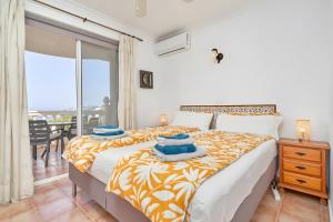 a bedroom with a bed with blue towels on it at Villa Estrella de Cotobro in Almuñécar +31 photos