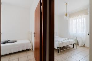 a room with two beds and a room with a window at Casa Giselle a Otranto in Otranto