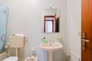 a bathroom with a sink and a toilet and a mirror at Casa Giselle a Otranto in Otranto +22 photos