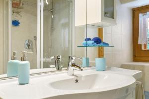 a bathroom with a sink and a mirror at Chalet Camillo in Moline +32 photos