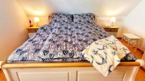 a bed with a black and white comforter at Ankerplatz in Lübeck in Lübeck