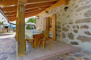 a patio with a table and chairs in a building at Chalet Camillo in Moline