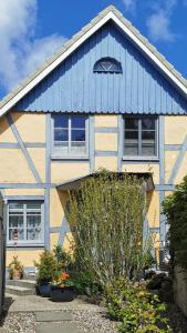 a yellow and blue house with a blue roof at Ankerplatz in Lübeck in Lübeck
