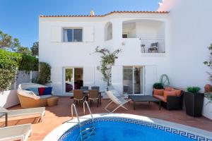 a villa with a swimming pool and a house at Vila Senna in Vale do Lobo