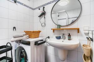 a white bathroom with a sink and a mirror at Haus Gertrud in Wiek auf Rügen +46 photos