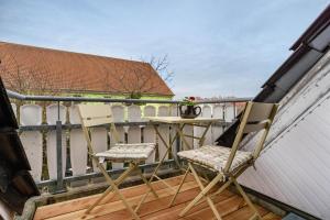 two chairs and a table on a balcony at Haus Gertrud in Wiek auf Rügen