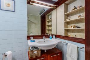 a bathroom with a sink and a mirror at Sunset Troia Beach in Troia