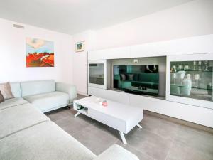 a living room with a couch and a tv at Apartment Alexia by Interhome in Ifach