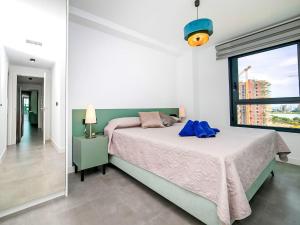 a bedroom with a bed and a large window at Apartment Alexia by Interhome in Ifach