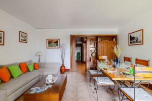 a living room with a couch and a table at Sunset Troia Beach in Troia +28 photos