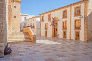 an empty courtyard of a building with a flag at Sol Mar Arzuaga in Jávea