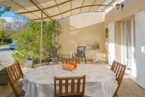a table with an orange on it on a patio at La Miellerie in Gréoux-les-Bains