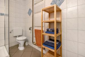 a bathroom with a wooden shelf with towels in it at De Olle Uhlhoff in Barlt +61 photos