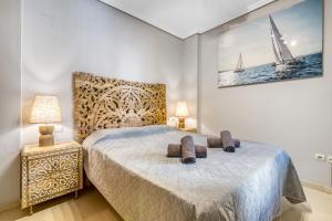 a bedroom with a bed with two pillows on it at Sol Mar Arzuaga in Jávea
