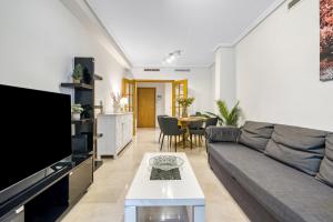 a living room with a couch and a table at Sol Mar Arzuaga in Jávea