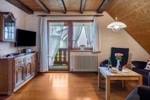 a living room with a couch and a table at Ferienhaus Brigitte - Breitnau in Breitnau