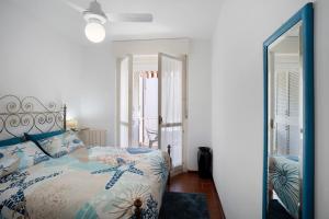 a bedroom with a bed and a mirror at Albenga Le Morelle 2 in Albenga