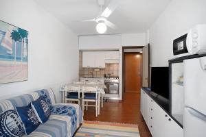 a living room with a couch and a kitchen at Albenga Le Morelle 2 in Albenga