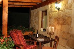 a patio with a table and two chairs and candles at Jörgs Ferienwohnung Lohmen in Lohmen