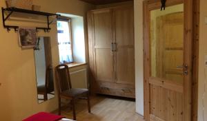 a room with a door and a chair and a window at Jörgs Ferienwohnung Lohmen in Lohmen