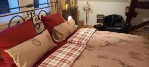 a bed with a blanket and pillows on it at Landhauswohnung Alte Mühle in Berlinghausen