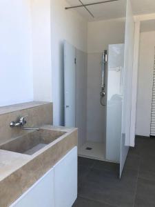 a bathroom with a sink and a shower at Lungomare Santa Caterina in Nardò +14 photos