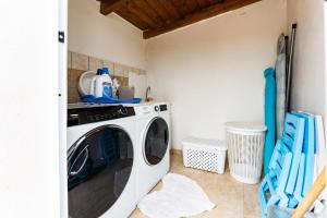 a washer and dryer in a kitchen with at Villa Harmony in Quartu SantʼElena
