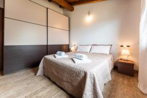 a bedroom with a bed with towels on it at Villa Harmony in Quartu SantʼElena