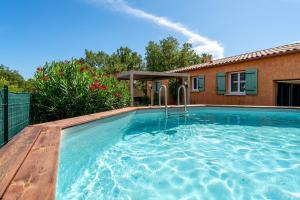 a swimming pool in front of a house at Villa piscine, clim in Méjannes-le-Clap