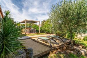 a garden with a picnic table and a gazebo at Villa piscine, clim in Méjannes-le-Clap