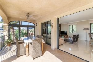 a dining room and living room with a table at Villa Mara in El Campello